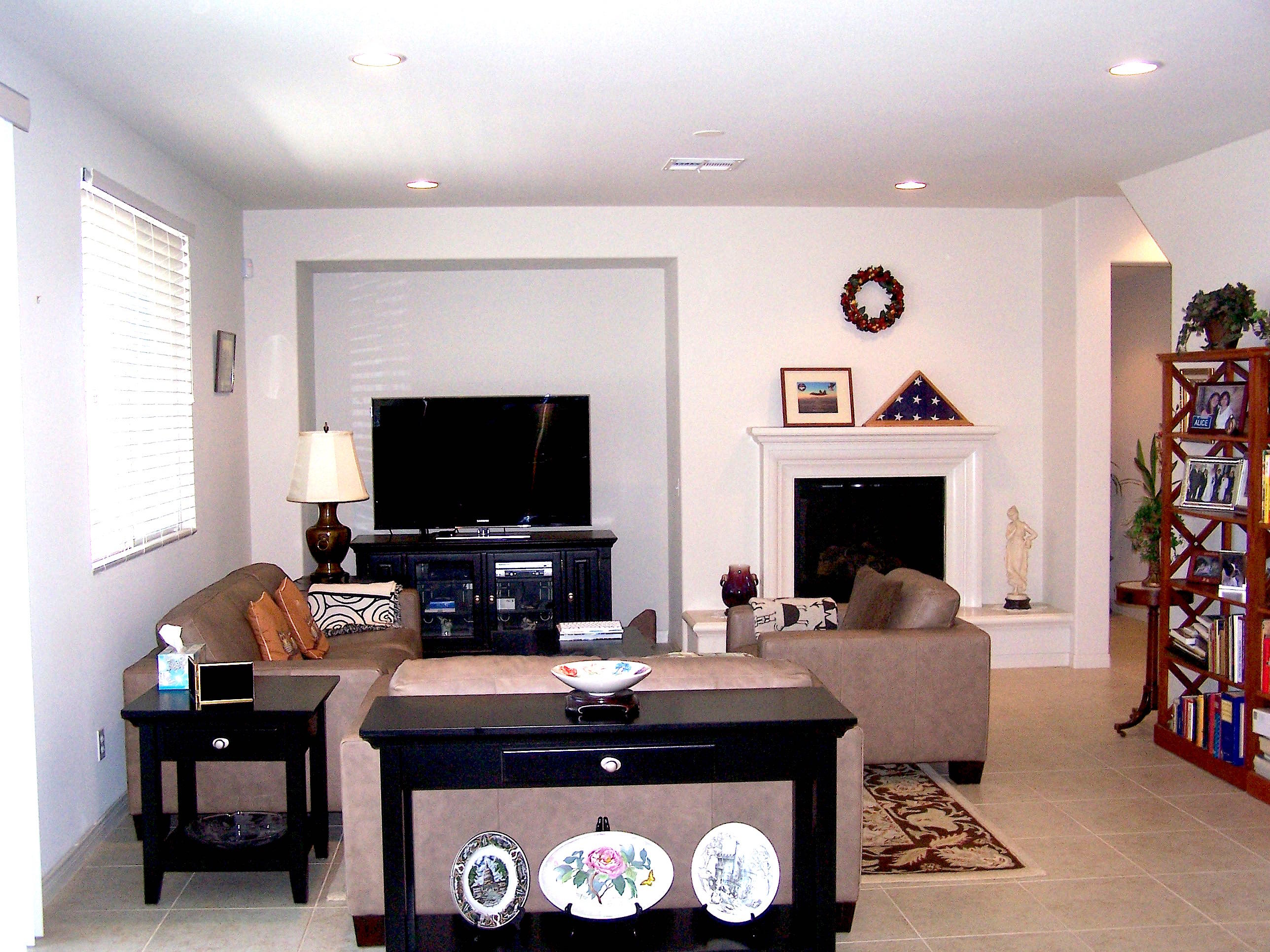 41713 Retsina Street Palmdale, CA 93551 - Photo 7 of 20 a living room with furniture a flat screen tv and a fireplace