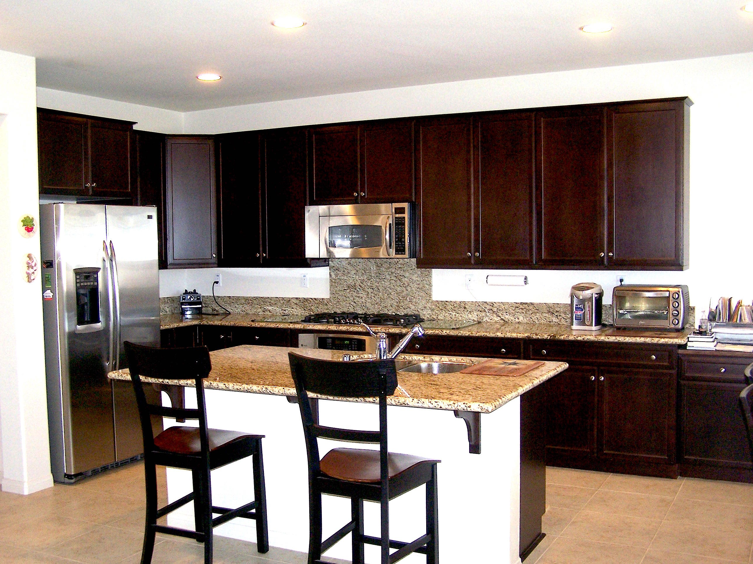 41713 Retsina Street Palmdale, CA 93551 - Photo 8 of 20 a kitchen with granite countertop a sink cabinets and stainless steel appliances
