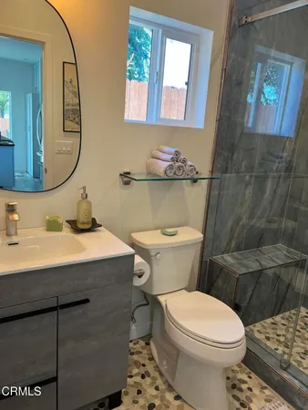 a bathroom with a sink mirror vanity and toilet