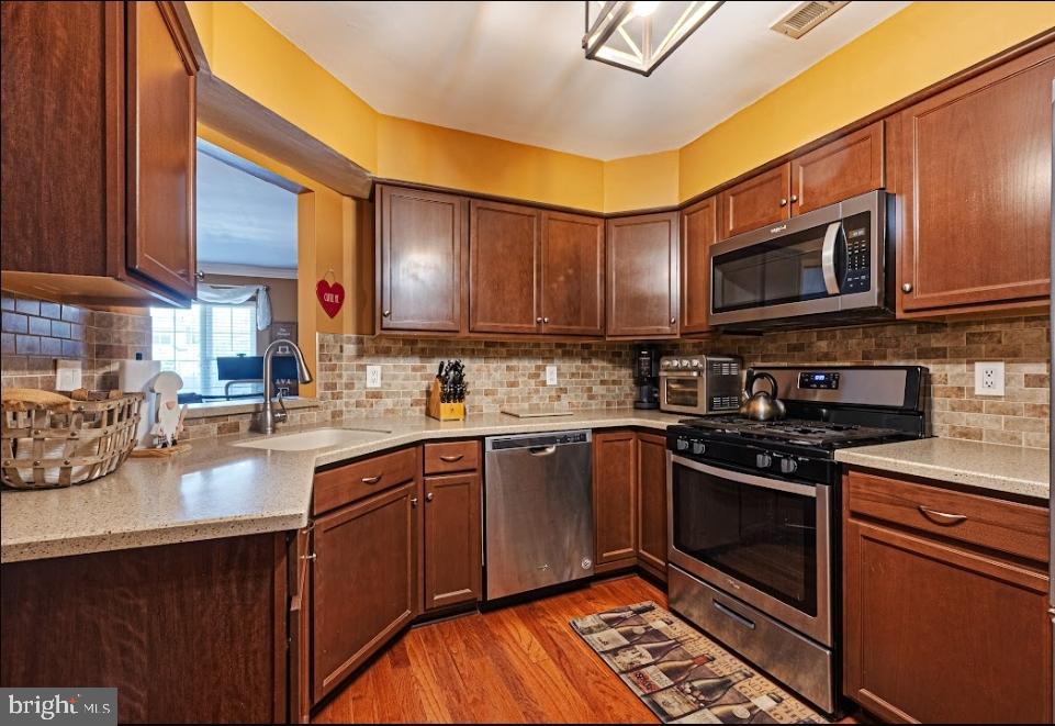 1202 Wharton Road Mount Laurel, NJ 08054 - Photo 15 of 31 a kitchen with stainless steel appliances granite countertop a stove sink microwave and cabinets
