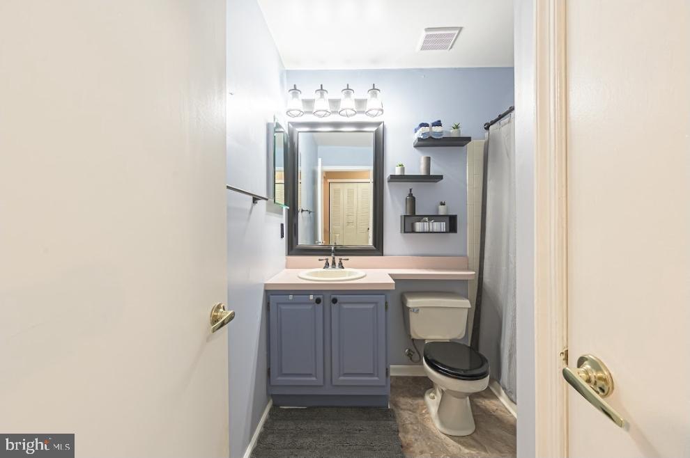 1202 Wharton Road Mount Laurel, NJ 08054 - Photo 18 of 31 a bathroom with a toilet a sink and mirror