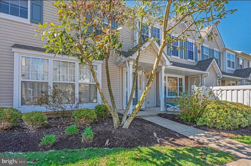 1202 Wharton Road Mount Laurel, NJ 08054 - Photo 2 of 31 a view of a brick house with a yard and plants