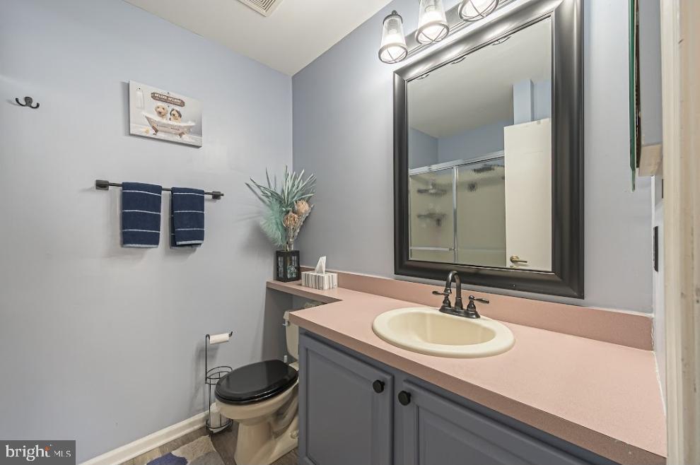 1202 Wharton Road Mount Laurel, NJ 08054 - Photo 22 of 31 a bathroom with a toilet a sink and mirror