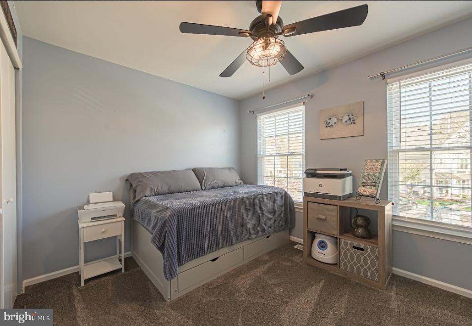 1202 Wharton Road Mount Laurel, NJ 08054 - Photo 24 of 31 a spacious bedroom with a bed and a chandelier