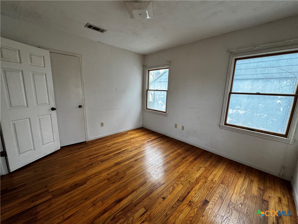 1010 South 17th Street Temple, TX 76504 - Photo 19 of 30 a view of empty room with wooden floor and fan