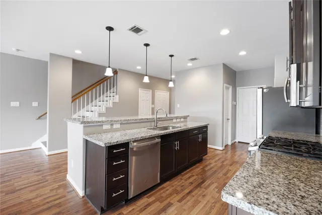 a kitchen with a stove a sink and a refrigerator