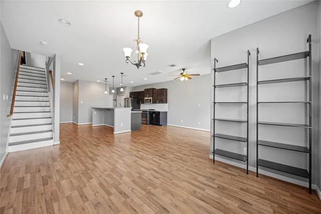 a view of a kitchen with cabinets and wooden floor