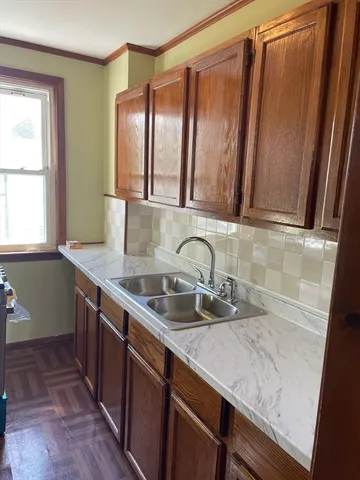 a kitchen with stainless steel appliances granite countertop a sink and a wooden cabinets