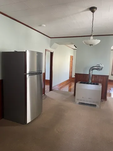 a kitchen with refrigerator and window