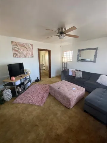 a bedroom with a bed a chandelier and a window