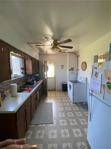 a large kitchen with stainless steel appliances a sink and counter space