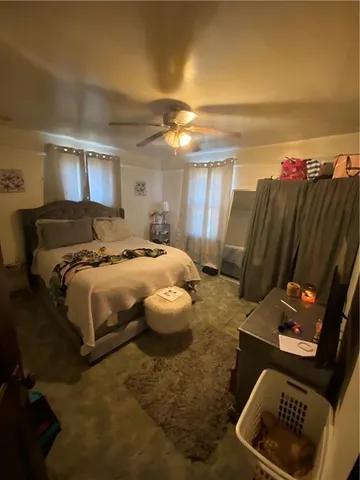 a bedroom with a bed and a television