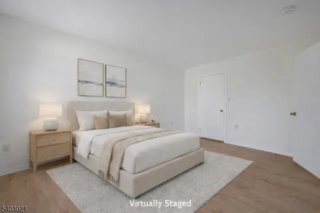 a bedroom with a bed and a night stand