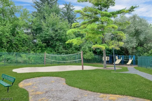 a view of a garden with a bench in the park