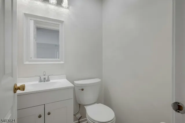 a white toilet sitting next to a bathroom sink