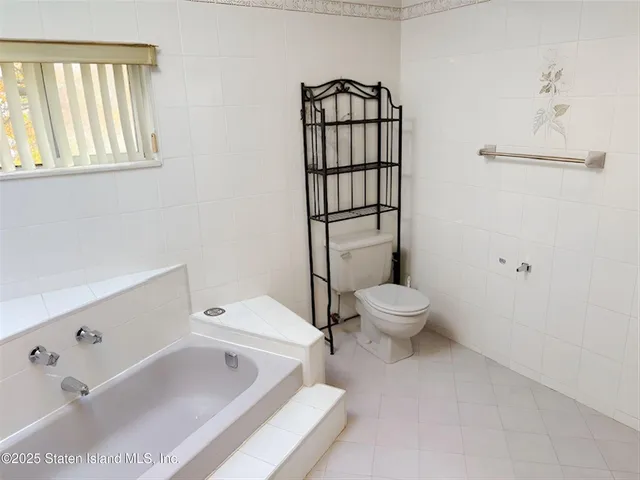 a bathroom with a toilet sink shower and mirror
