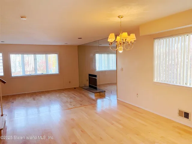a view of a room with wooden floor and windows
