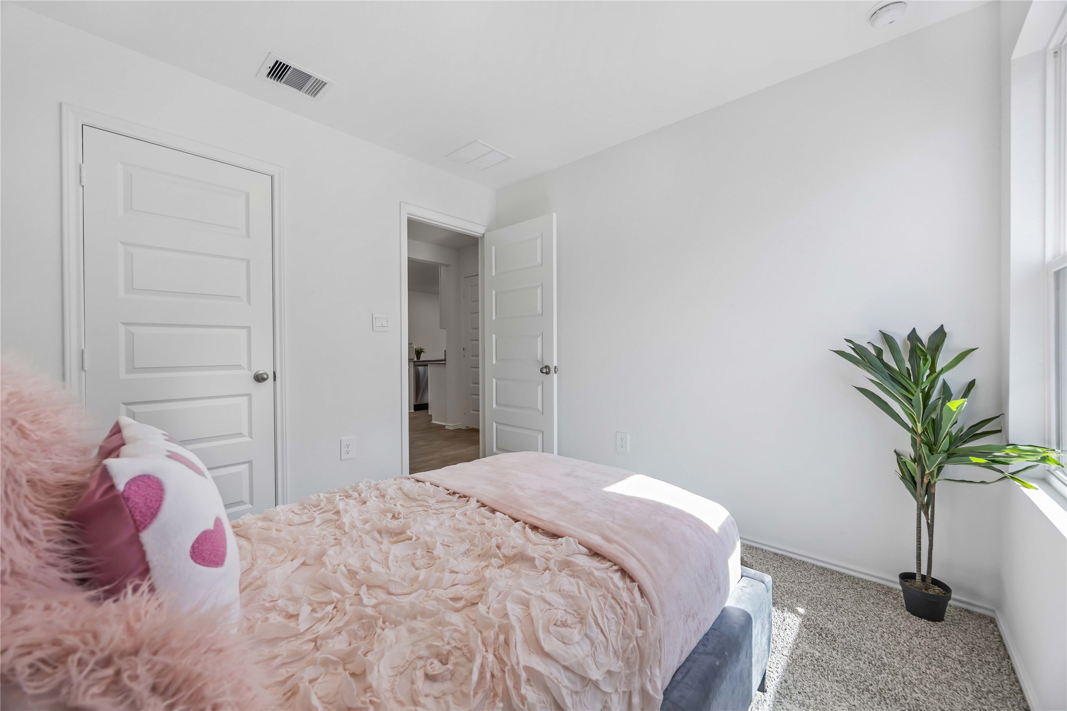 11910 Lilac Ice Lane Houston, TX 77048 - Photo 16 of 17 a bedroom with a bed and a potted plant
