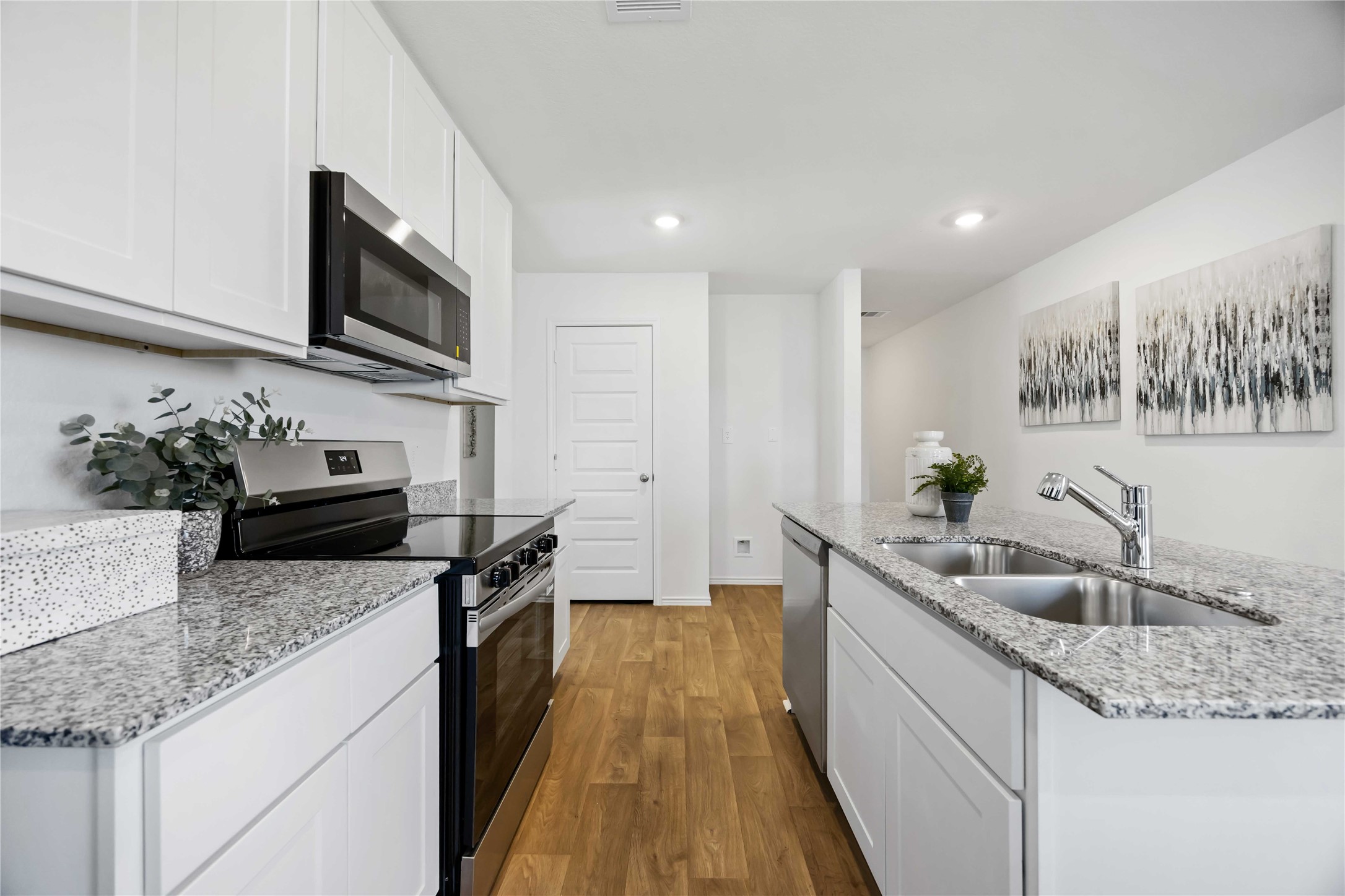 11910 Lilac Ice Lane Houston, TX 77048 - Photo 5 of 17 a kitchen with granite countertop stainless steel appliances a sink a stove top oven a counter space and cabinets