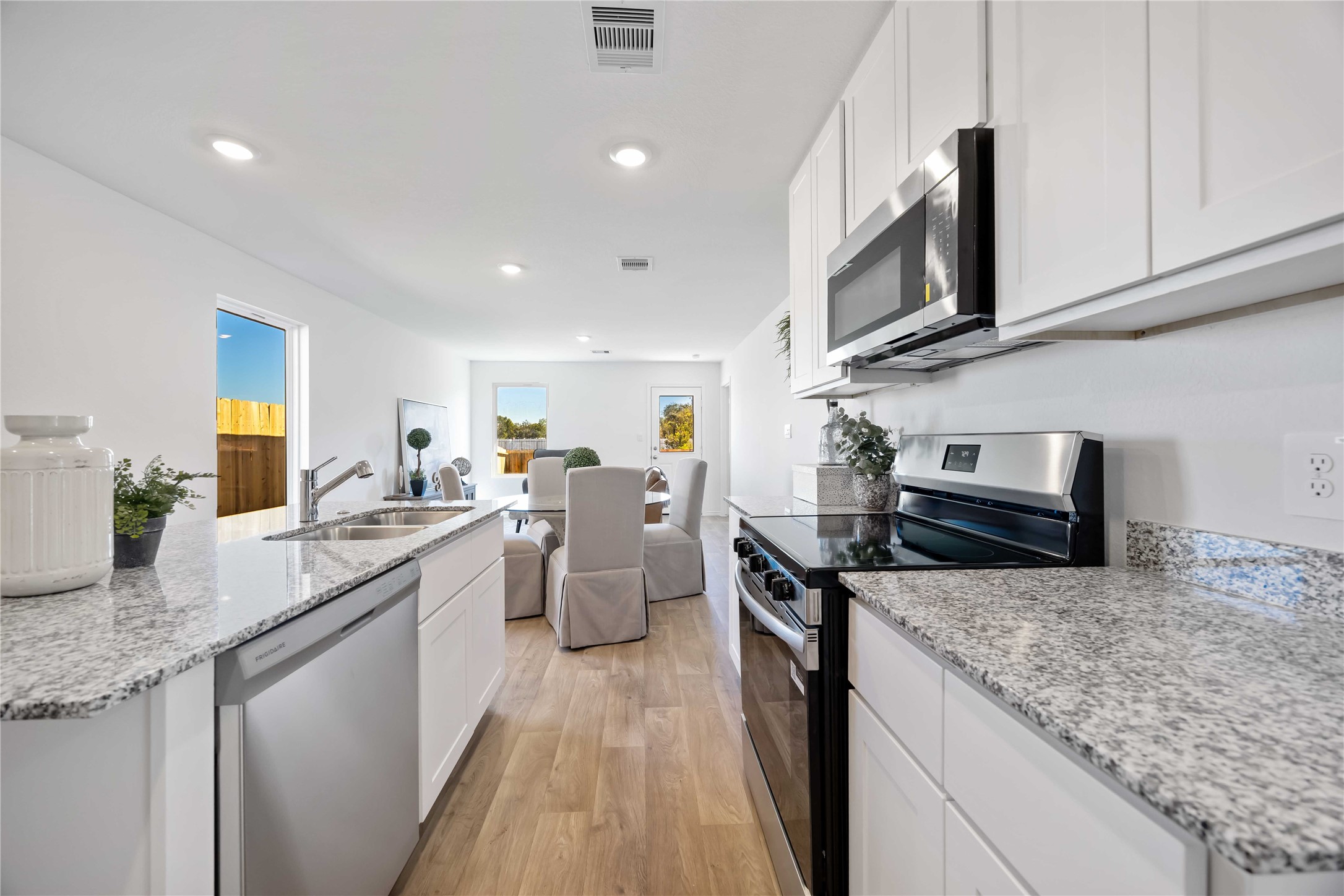 11910 Lilac Ice Lane Houston, TX 77048 - Photo 6 of 17 a kitchen with stainless steel appliances granite countertop a sink stove and refrigerator