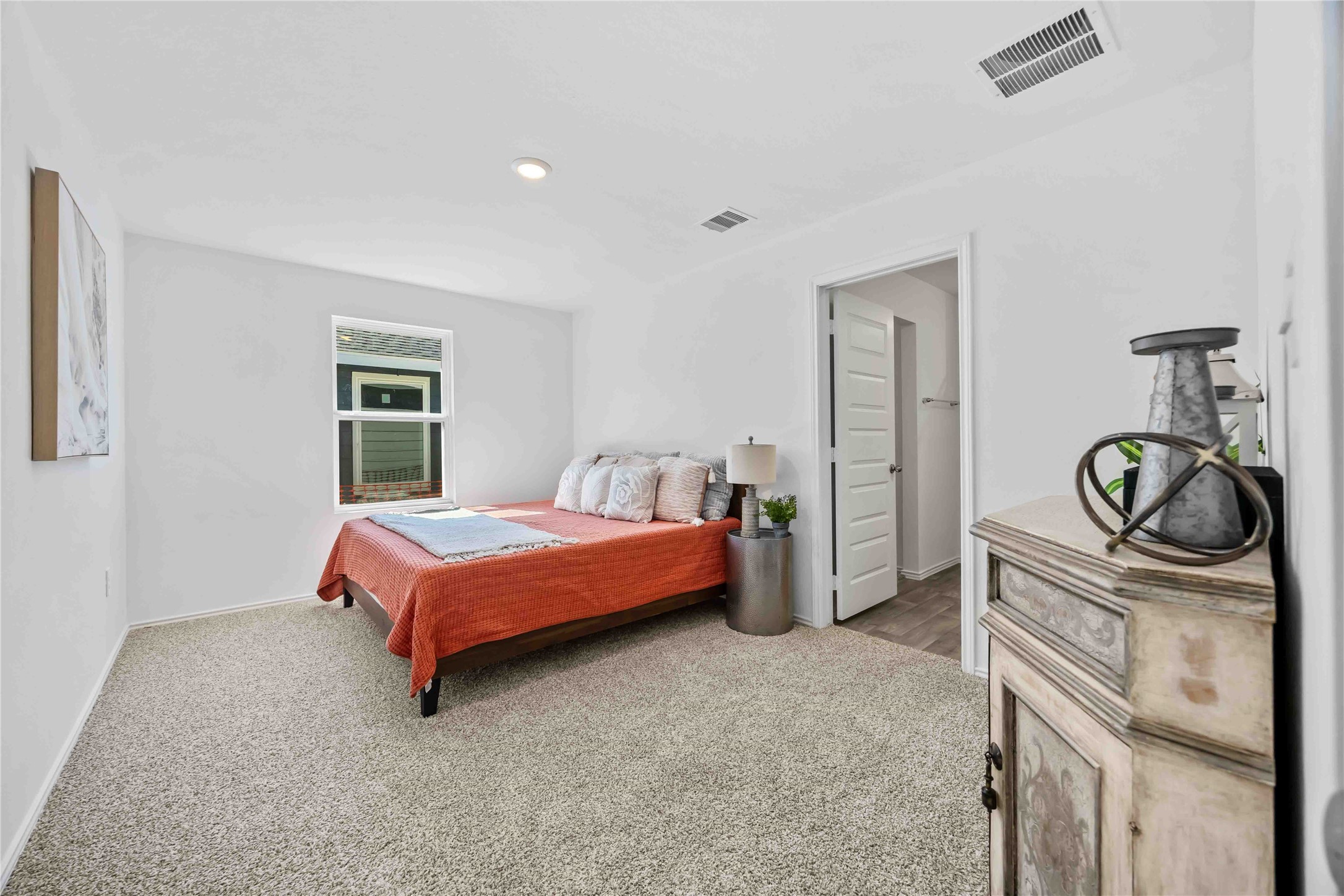 11910 Lilac Ice Lane Houston, TX 77048 - Photo 10 of 17 a bedroom with a bed and cabinets