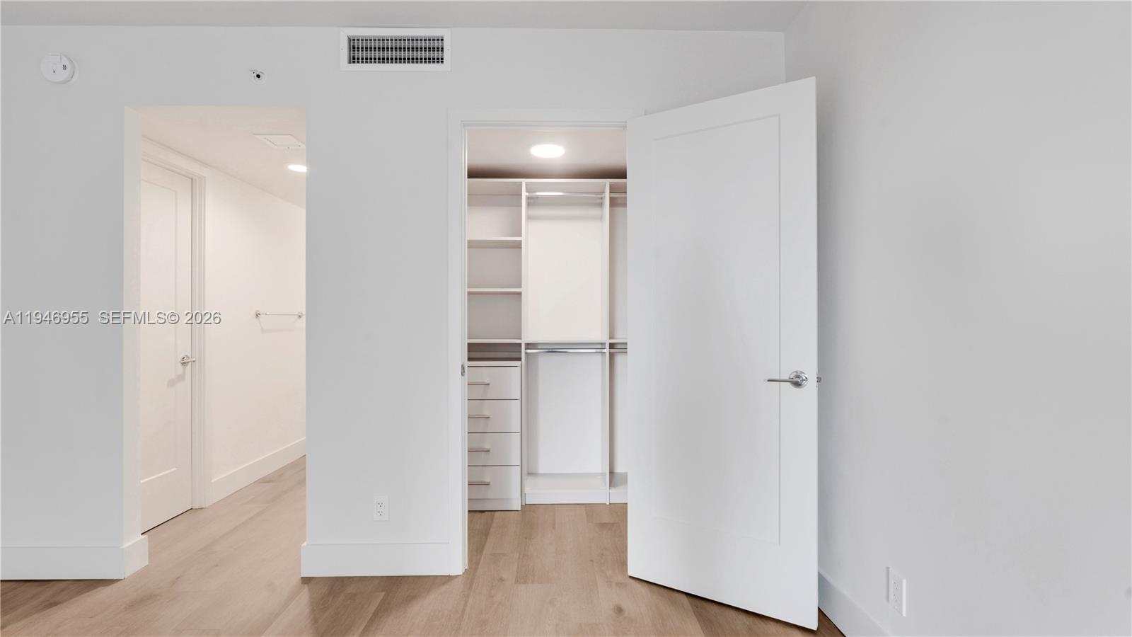 555 Northeast 34th Street, Unit 1509 Miami, FL 33137 - Photo 25 of 32 a view of empty walk in closet with wooden floor