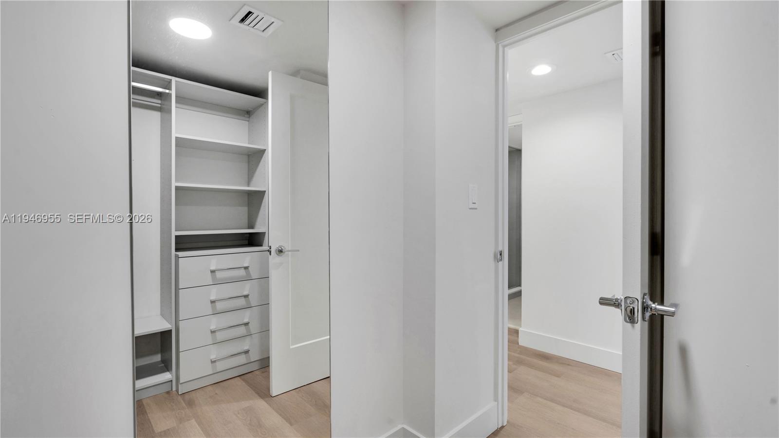 555 Northeast 34th Street, Unit 1509 Miami, FL 33137 - Photo 32 of 32 a view of walk in closet with empty racks