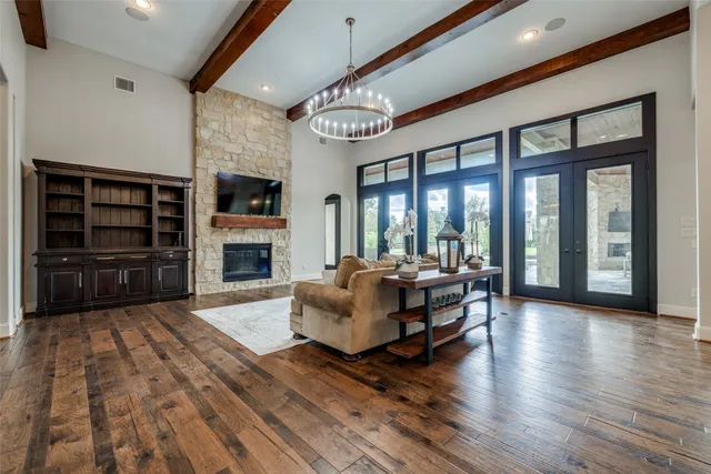 a living room with furniture large window and a flat screen tv