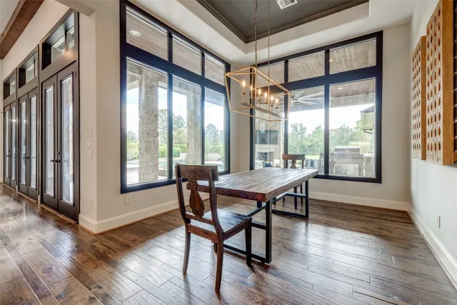 a kitchen with stainless steel appliances granite countertop white cabinets and a stove top oven