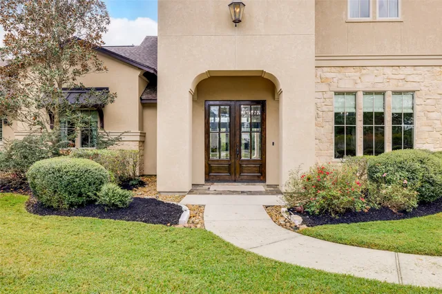 a spacious bedroom with a bed and a large window