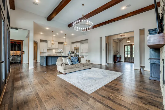 a living room with furniture and a chandelier