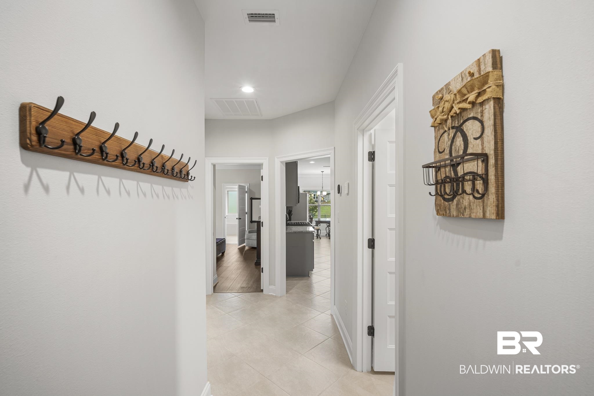 12672 Squirrel Drive Daphne, AL 36527 - Photo 20 of 49 Hallway featuring light-toned tile flooring, recessed lighting, and bright white walls