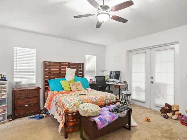 a bedroom with a bed and a chandelier