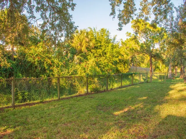 a view of yard with swimming pool and green space
