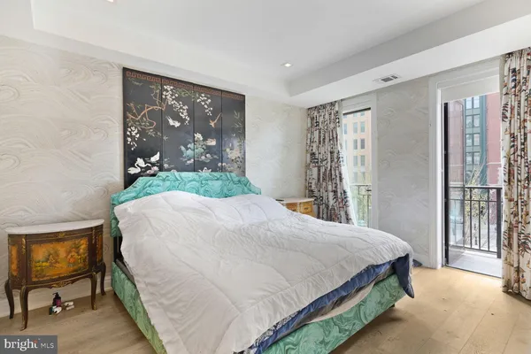 a spacious bedroom with a bed and a couch