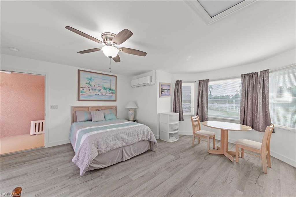 13541 Stringfellow Road Bokeelia, FL 33922 - Photo 26 of 49 a bedroom with a bed and a large window