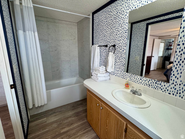 972 Ridgeway Loop, Unit 228 Garden City, UT 84028 - Photo 12 of 26 Master Full bathroom featuring a textured ceiling, shower / bath combination with curtain, vanity