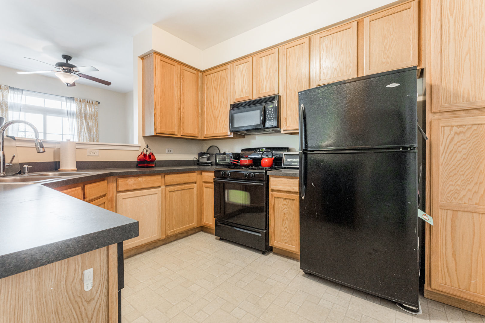 1936 West Cobblestone Road Romeoville, IL 60446 - Photo 4 of 25 a kitchen with a refrigerator a sink and a stove