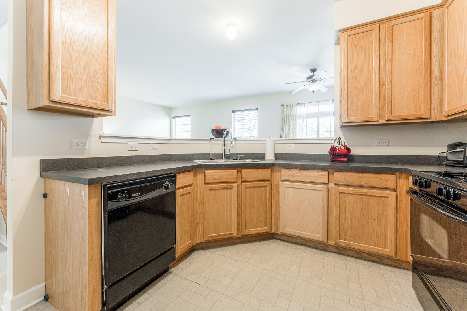 1936 West Cobblestone Road Romeoville, IL 60446 - Photo 5 of 25 a kitchen with stainless steel appliances granite countertop a sink stove and cabinets