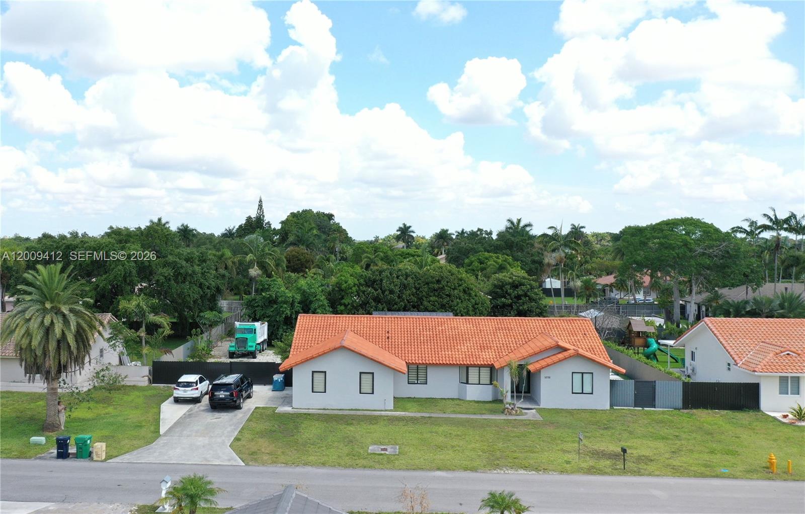 a aerial view of houses with yard