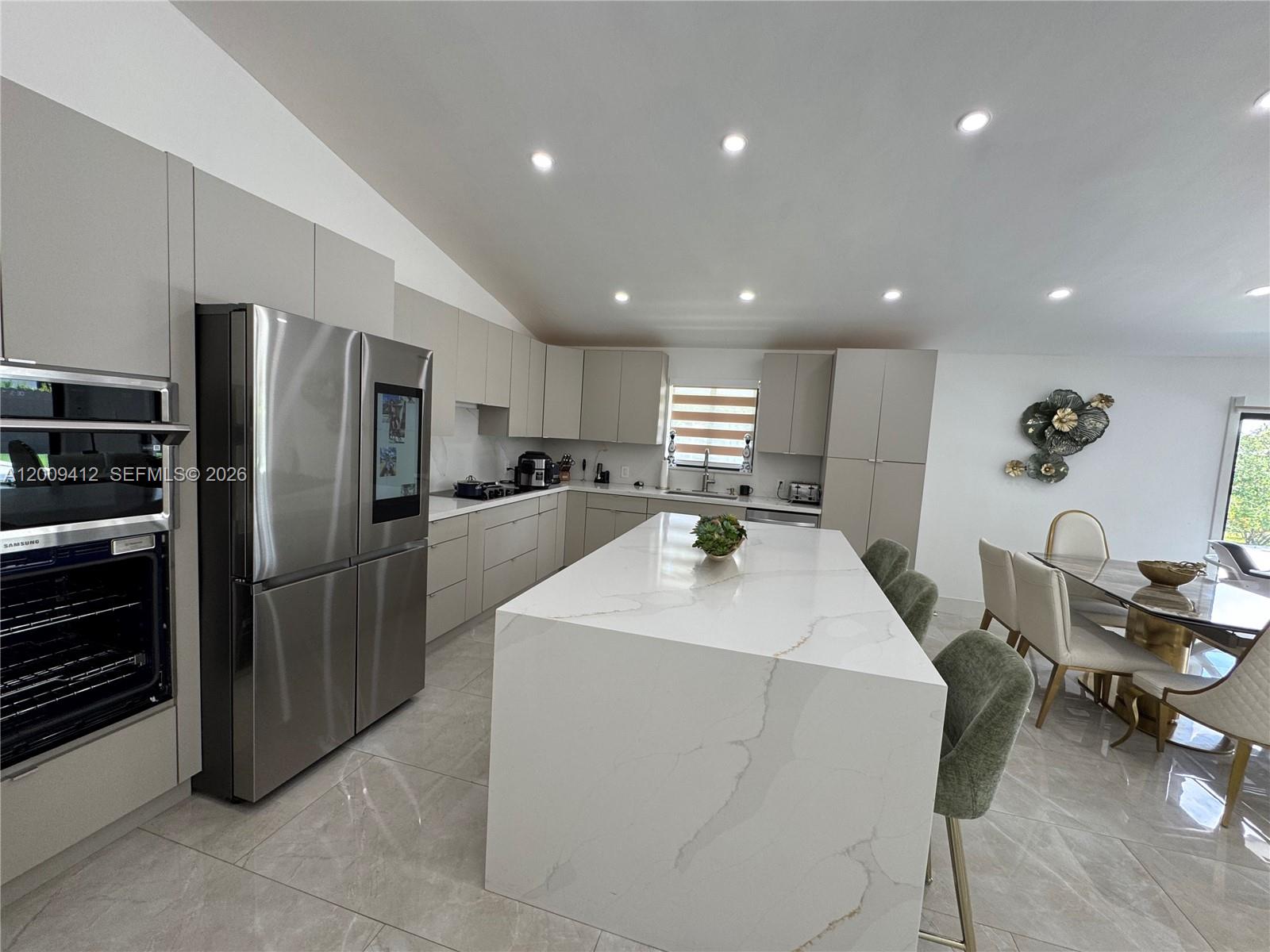 18781 Southwest 294th Terrace Homestead, FL 33030 - Photo 11 of 44 a kitchen with refrigerator and chairs