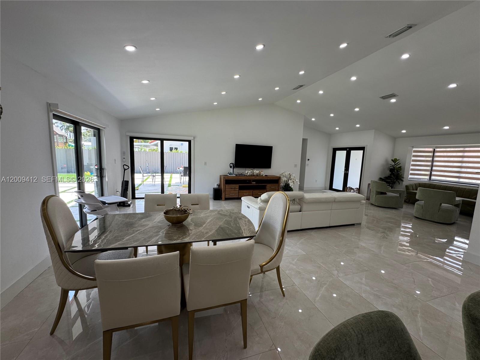 18781 Southwest 294th Terrace Homestead, FL 33030 - Photo 12 of 44 a view of a dining room with furniture a kitchen and chandelier