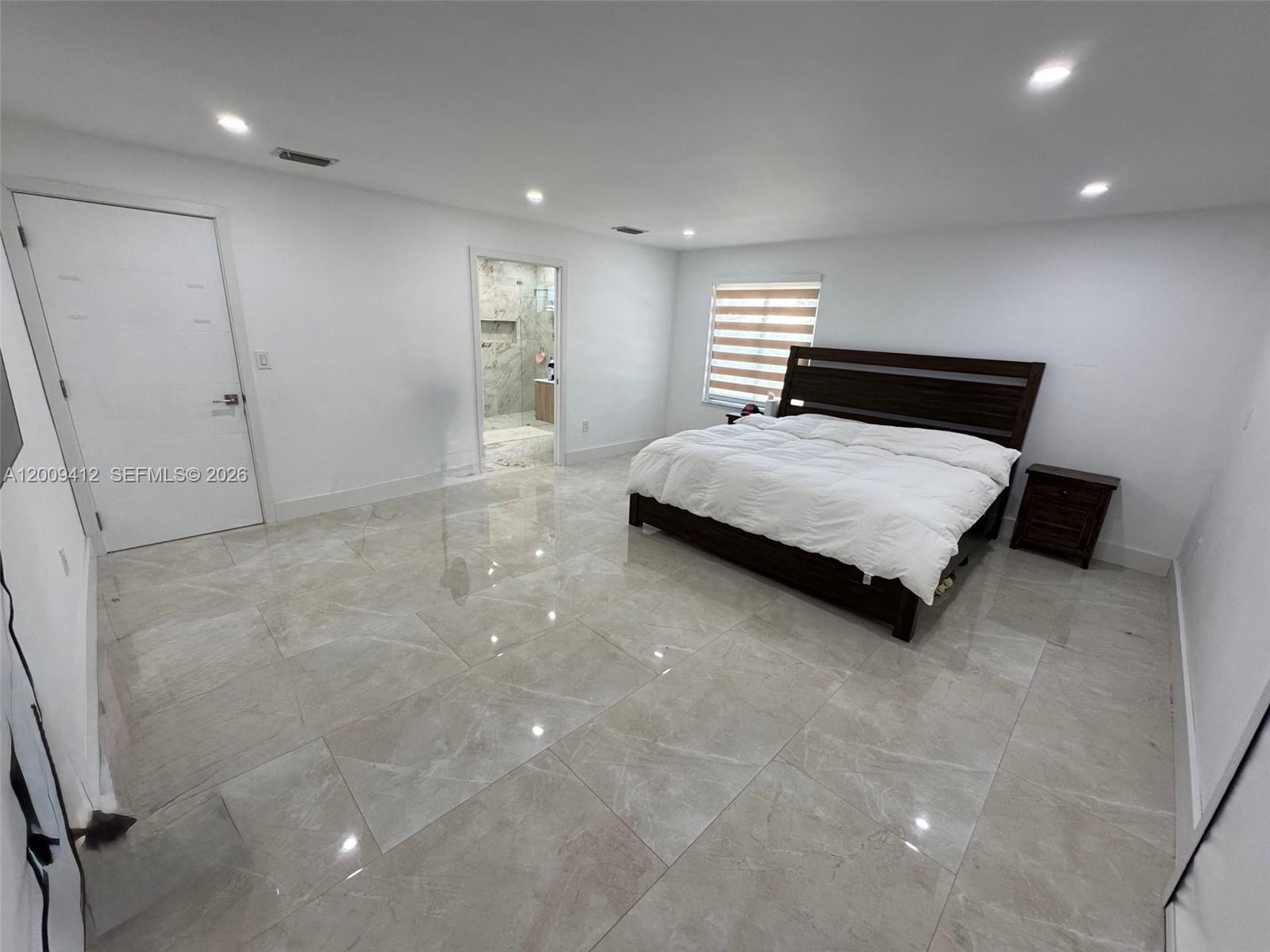 18781 Southwest 294th Terrace Homestead, FL 33030 - Photo 13 of 44 a spacious bedroom with a bed and a night stand