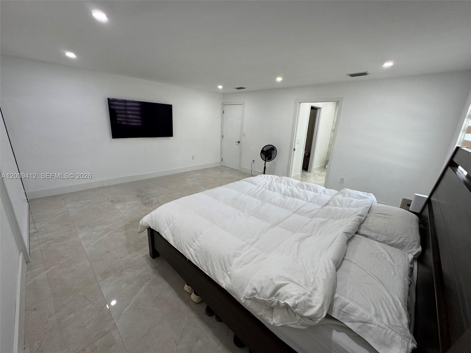 18781 Southwest 294th Terrace Homestead, FL 33030 - Photo 14 of 44 a bedroom with a bed and a flat screen tv