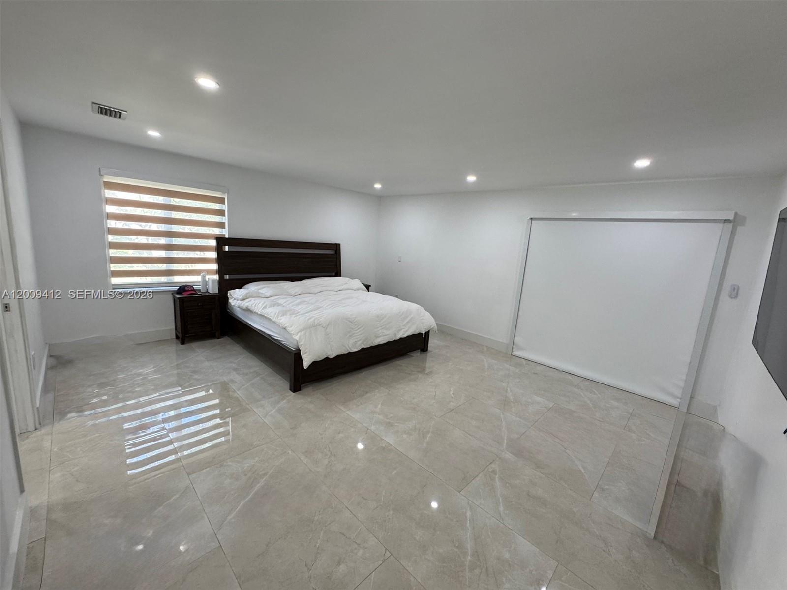 18781 Southwest 294th Terrace Homestead, FL 33030 - Photo 15 of 44 a bedroom with a bed and a large mirror