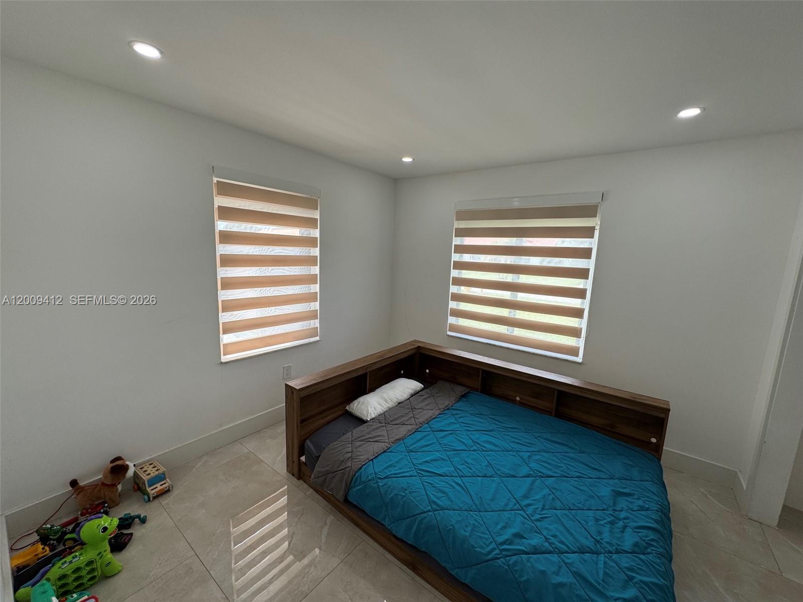 18781 Southwest 294th Terrace Homestead, FL 33030 - Photo 20 of 44 a bedroom with a bed and a window