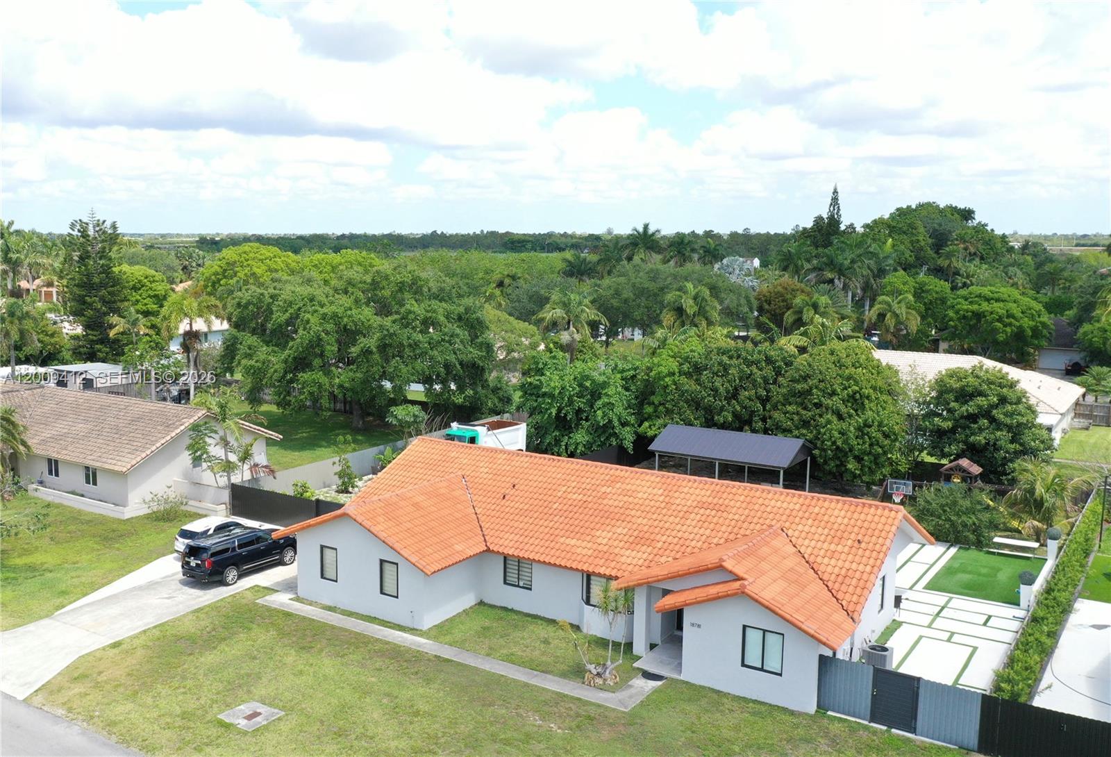 18781 Southwest 294th Terrace Homestead, FL 33030 - Photo 2 of 44 an aerial view of a house with pool patio and outdoor seating