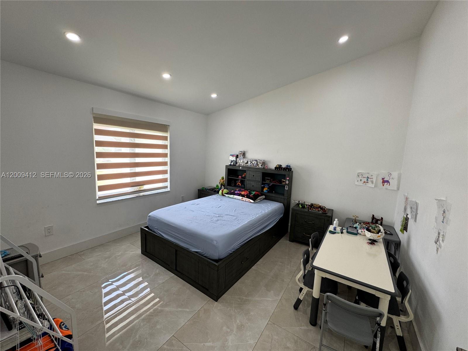 18781 Southwest 294th Terrace Homestead, FL 33030 - Photo 25 of 44 a bedroom with a bed a desk and chair