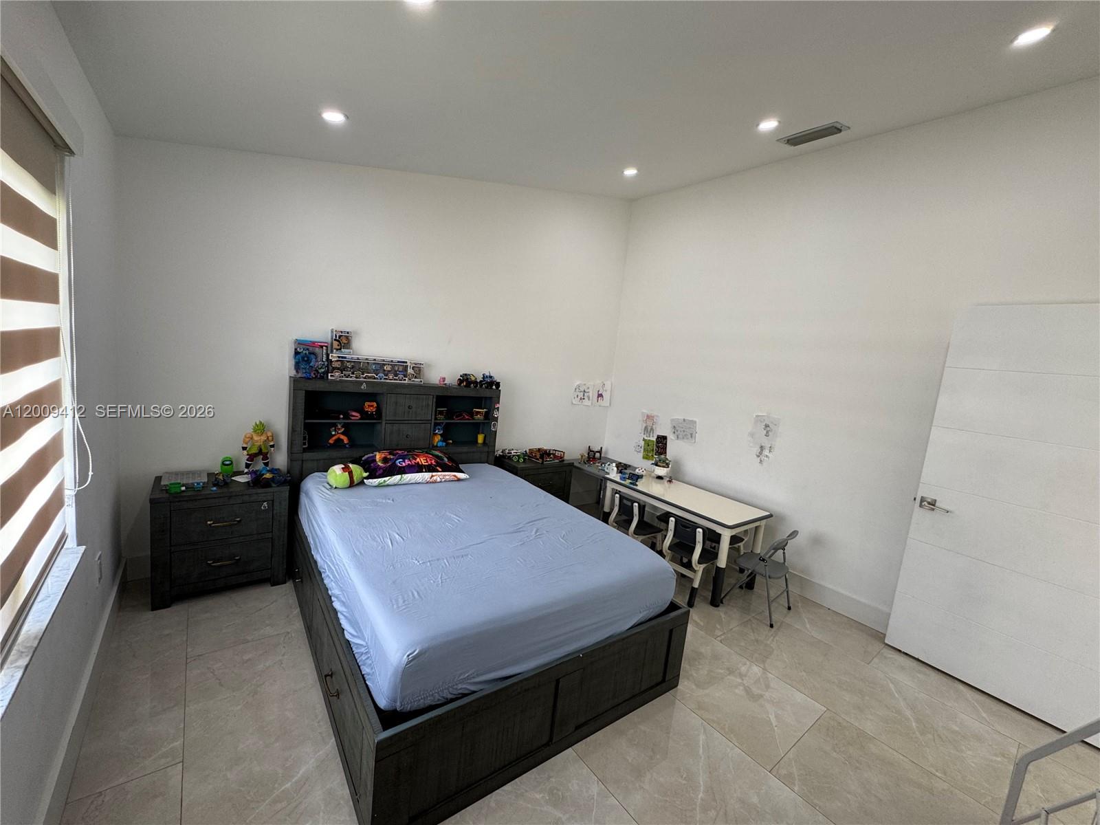 18781 Southwest 294th Terrace Homestead, FL 33030 - Photo 26 of 44 a bedroom with a bed and a desk