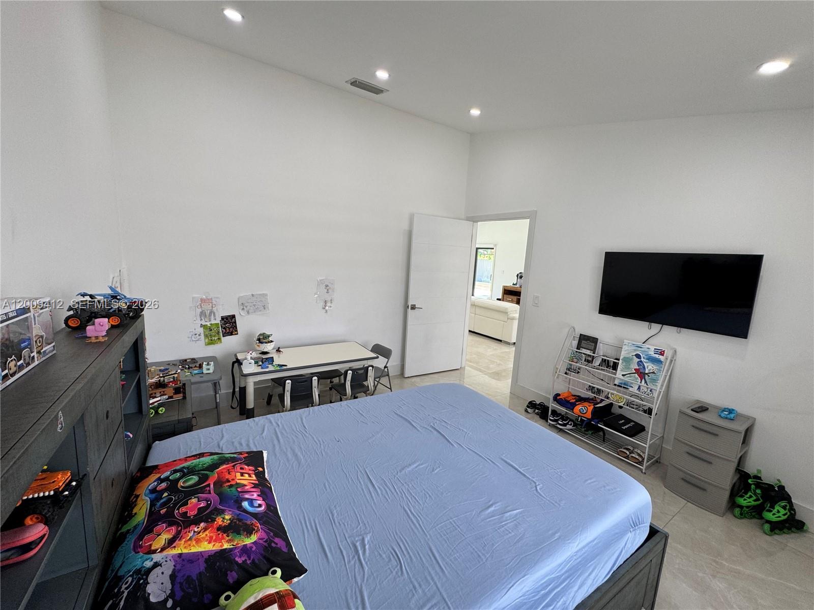 18781 Southwest 294th Terrace Homestead, FL 33030 - Photo 27 of 44 a bedroom with furniture and flat screen tv